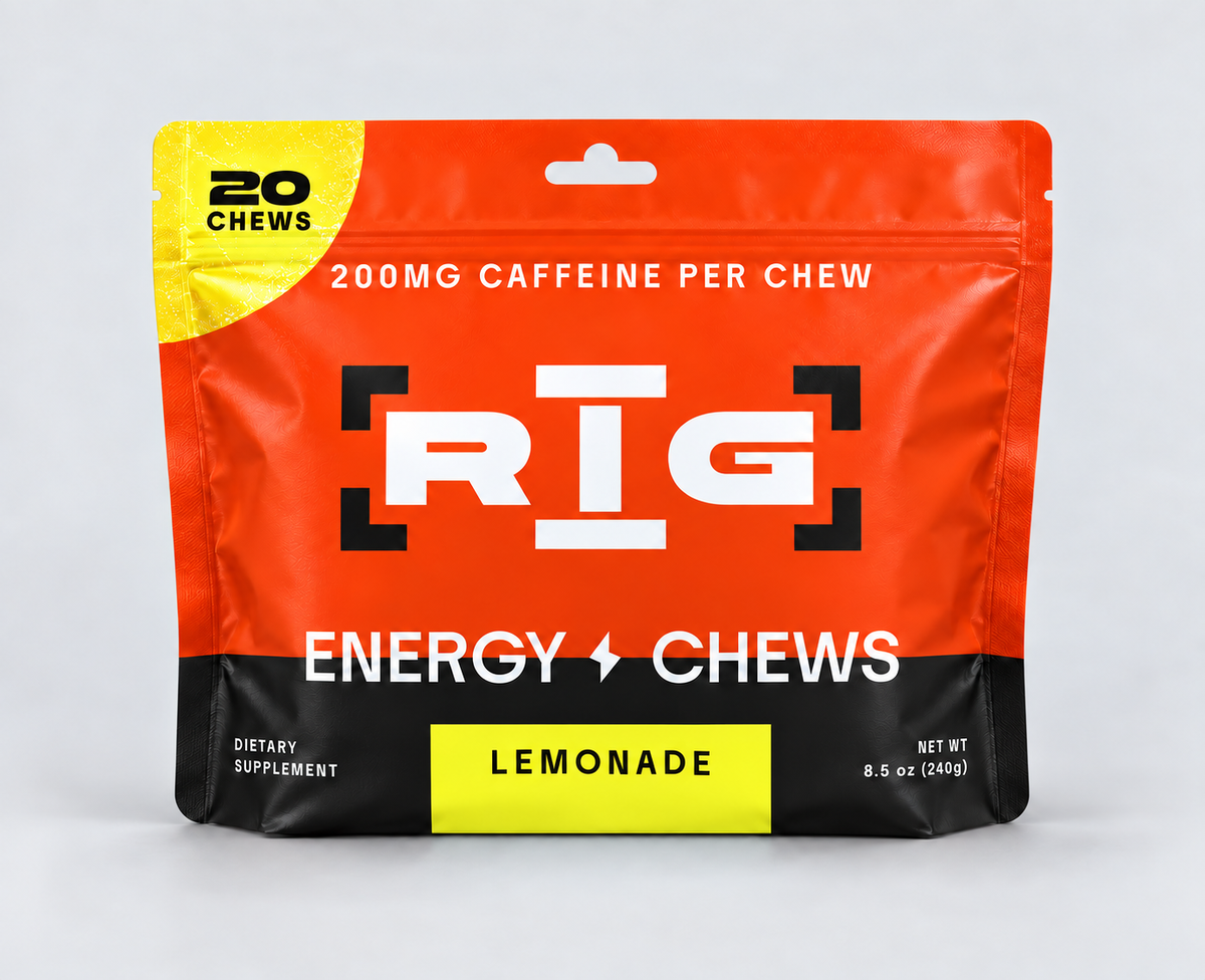 A stand-up pouch of RIG Energy Chews Lemonade flavor, featuring a bright orange and black design with a yellow accent, on a light gray background.