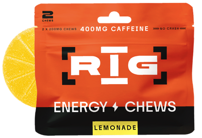 A package of RIG Energy Chews Lemonade flavor, featuring a bright orange and black bag with a yellow lemon slice graphic on the left, indicating two 200mg caffeine chews inside.